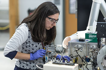 Photo of a student working on a project. Links to Blog