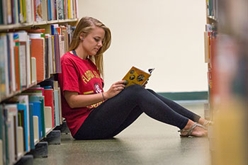 Photo of a student reading. Link to Life Stage Gift Planner Over Age 65 Situations.