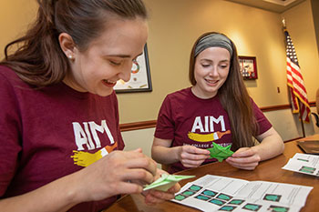 Photo of students working on a project. Links to Tangible Personal Property